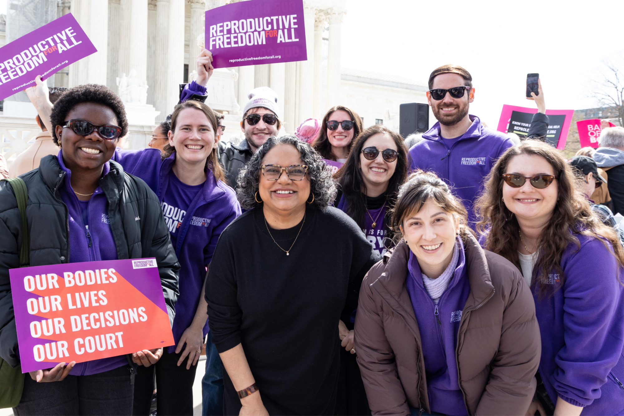 Group photo of people holding signs for Reproductive Freedom for All to in front of the Supreme Court