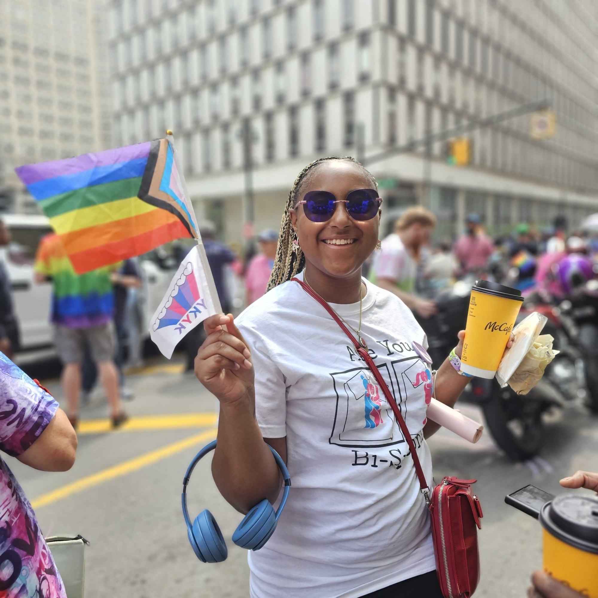 Repro for All member holding LGBTQIA+ flag