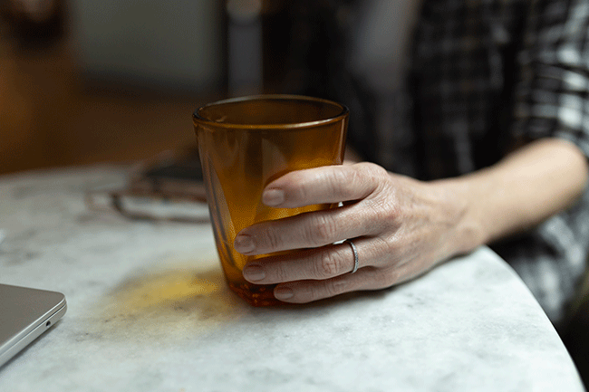 Person's hand holding a glass